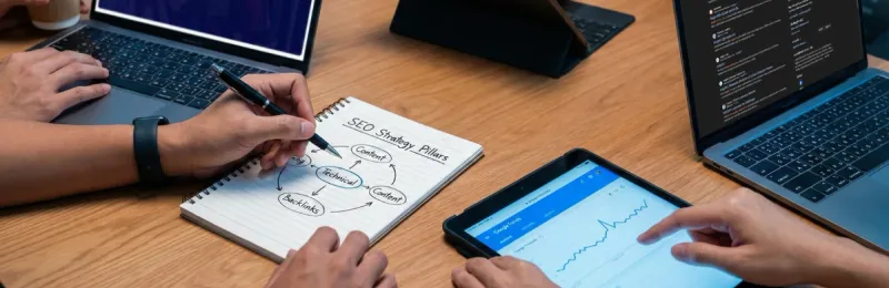 Brainstorming on a whiteboard to build long-term search marketing strategies and organic growth.